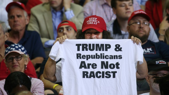 A supporter reacts by showing a t-shirt as U.S. President Donald Trump speaks during a campaign rally in Cincinnati